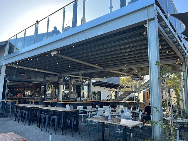 Outdoor commercial mezzanine floor above bar and dining area at a hospitality venue in Perth