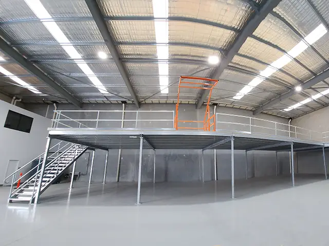 Steel mezzanine floor installed in a Perth warehouse with safety gate and stair access